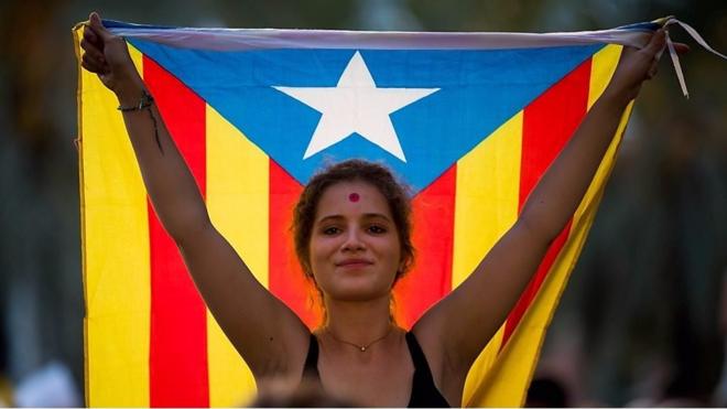 巴塞羅那加泰隆尼亞高等法院前一名支持獨立的女示威者舉起加泰隆尼亞星旗（21/9/2017）
