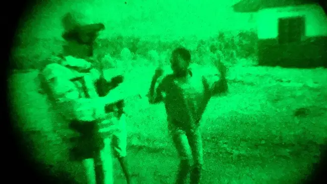 A child at one of the camps reacts to peacekeeping troops appearing on patrol. Displaced sites are numerous, and often dispersed in isolated areas.