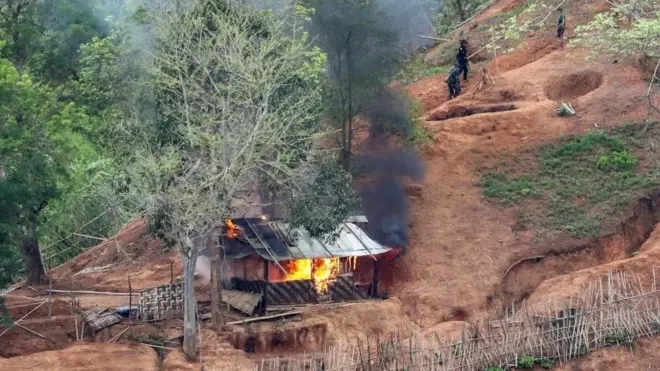 Ethnic minority Karen troops are seen after setting fire to a building inside a Myanmar army outpost near the Thai border, which is seen from the Thai side on the Thanlwin, also known as Salween, riverbank in Mae Hong Son province, Thailand, April 28, 2021