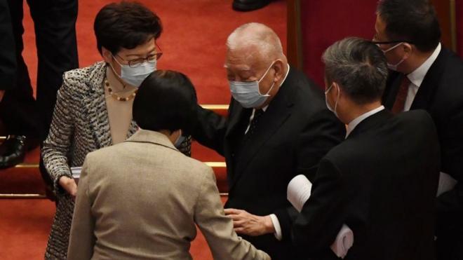 全國政協副主席、香港前行政長官董建華在北京人民大會堂列席人大會議後跌倒，眾人攙扶。
