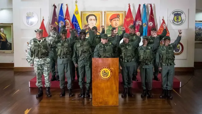 Глава министерства обороны Венесуэлы Владимир Падрино Лопес (в центре) во время пресс-конференции в Каракасе