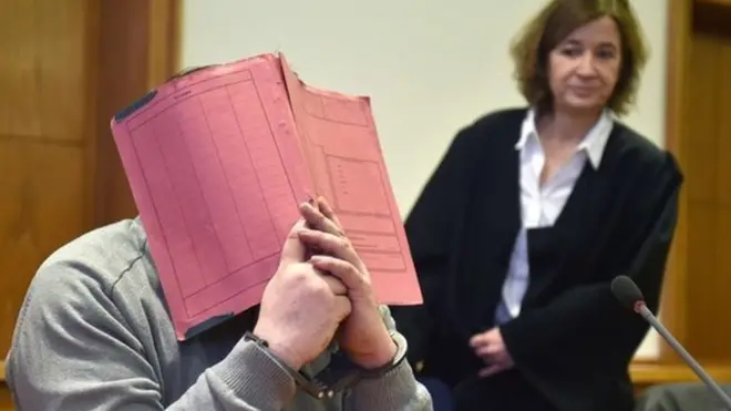 Niels H hid behind a folder as he awaited sentence at his 2015 trial