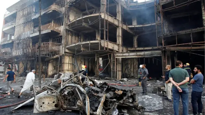 People gather at the site of a suicide car bomb in the Karrada shopping area, in Baghdad, Iraq July 3, 2016