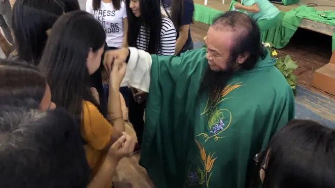 Father at Chito at church in university gymnasium