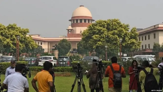 Indian media gathered outside the Supreme Court in Delhi for the verdict