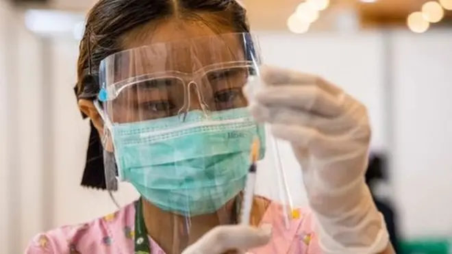 A nurse administers a vaccine