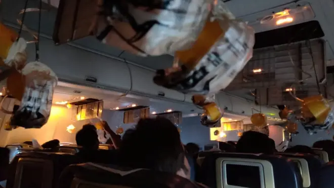 Oxygen masks are seen deployed after a loss of cabin pressure, on a Jet Airways flight, from Mumbai