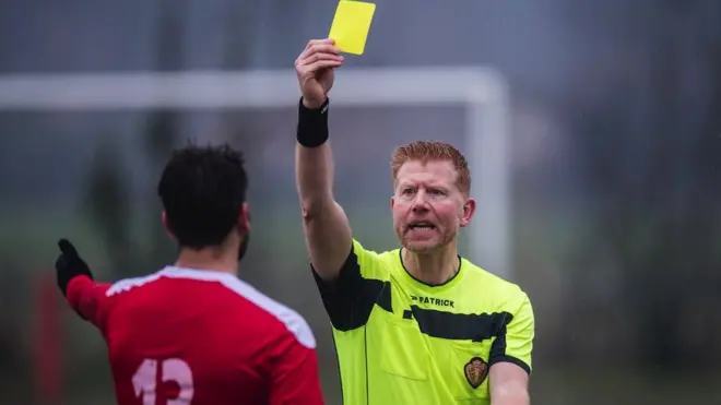 Frederik Imbo refereeing a football match