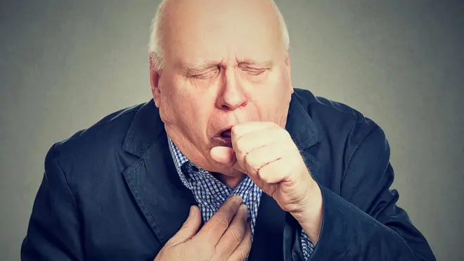 man coughing