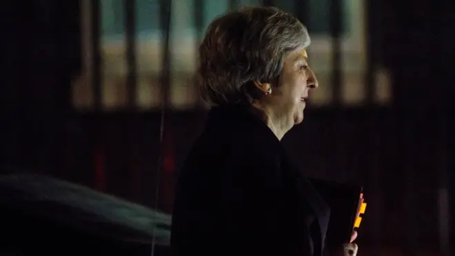 Theresa May arrives at No 10 after postponing the Commons vote on her Brexit deal