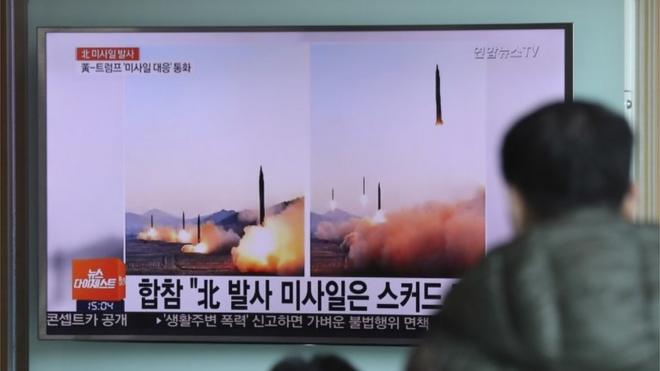 Man watches TV report on North Korean launches in Seoul
