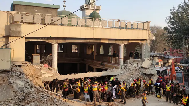 Rescue workers at the scene of a blast at a Mosque, in Peshawar, Pakistan, 30 January 2023
