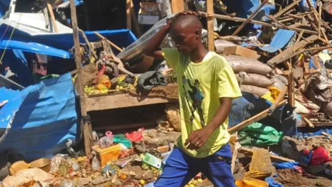 A resident walks over a blood stain on the ground at the scene of a suicide car bomb attack in Somalia's restive capital, Mogadishu.