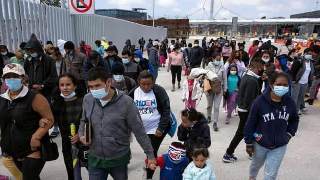 Migrants attend a demonstration at the San Ysidro crossing port asking US authorities to allow them to start their migration process in Tijuana, Baja California state, Mexico on March 23, 2021