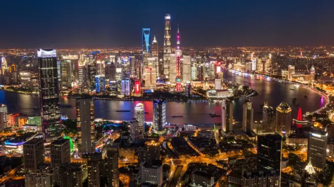 Skyscrapers and a river in the city of Shanghai at night