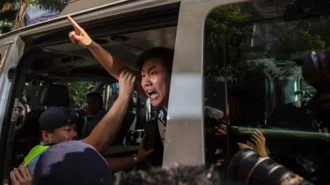 League of Social Democrats member Raphael Wong is taken away by police during a protest in Hong Kong