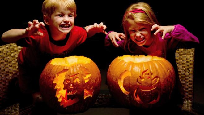 Children with pumpkins.