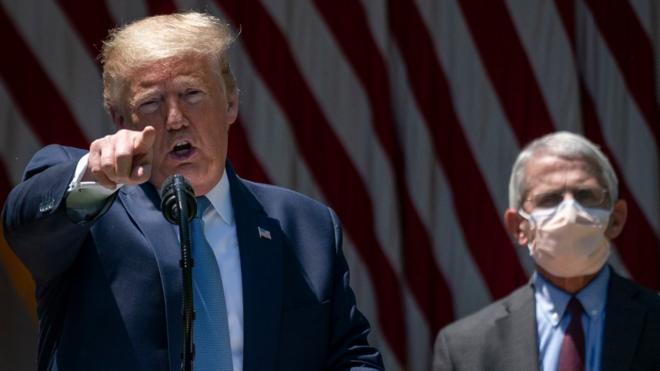 Dr. Anthony Fauci looks on as U.S. President Donald Trump delivers remarks about coronavirus vaccine development in the Rose Garden of the White House on May 15, 2020 in Washington, DC.