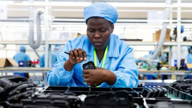 Ugandan factory workers assemble mobile phone cases at a factory in Kampla