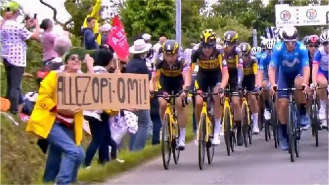 The spectator can be seen holding a sign