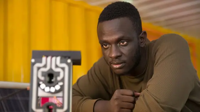 Matibabu shines a red beam through a patient's finger and detects tell-tale signs of malaria