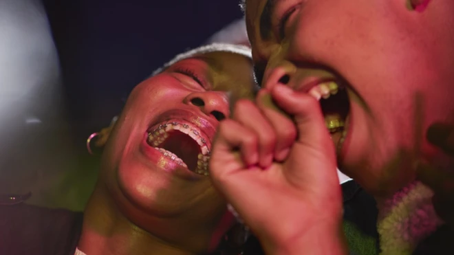 Cheerful couple enjoying comedy movie together at theatre