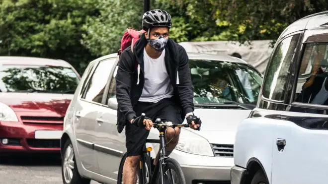 A cyclist next to traffic