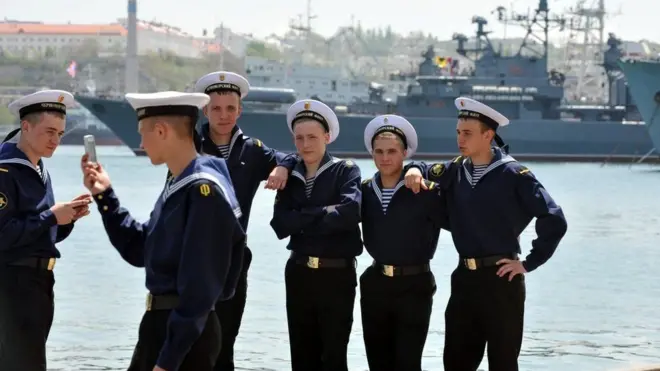 Russian sailors take selfies in the naval base at Sevastopol, Crimea