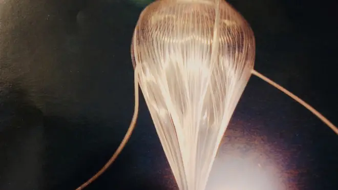 The weather balloon being inflated at launch, which would become spherical at higher altitudes