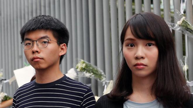 Joshua Wong, left, and Agnes Chow, right, at a protest in Hong Kong