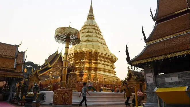 Devotees prepare large candles at Doi Suthep Buddhist temple in the northern Thai province of Chiang Mai
