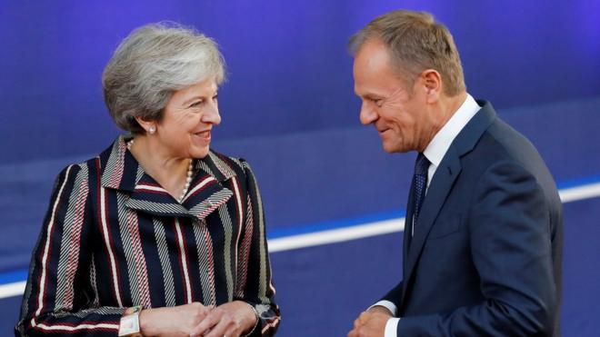 European Council President Donald Tusk and Britain's Prime Minister Theresa May talk on 19 October
