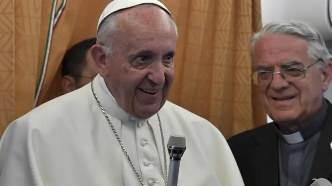 Pope Francis, flanked by Vatican spokesman Federico Lombardi, talks to journalists on flight back to Vatican, at end of three-day visit to Armenia, Sunday, June 26