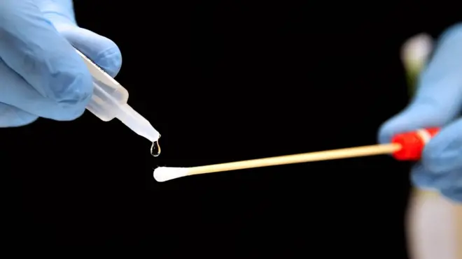 A member of the forensic section of the French gendarmerie (Cellule d'Identification Criminelle, CIC) prepares a small stick to collect DNA in a laboratory of the gendarmerie in Beauvais on November 21, 2013.