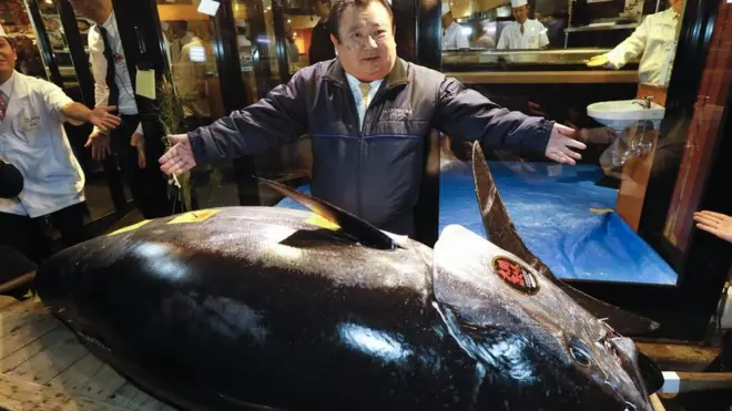 Mr Kimura with the 278kg (612lbs) bluefin tuna he bought