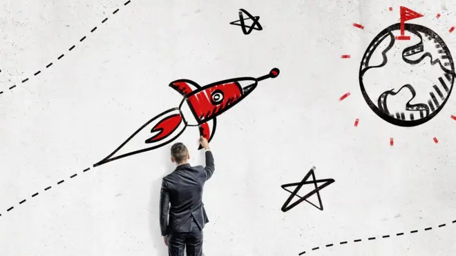 Un homme dessinant une fusée