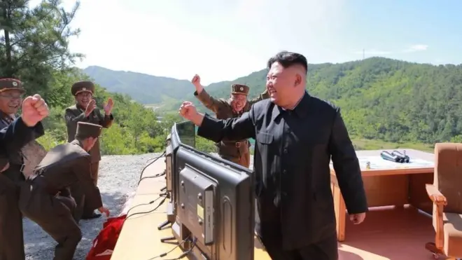 North Korean leader Kim Jong-un (right) reacts during the test of the Hwasong-14 missile in this undated photo released by North Korea's KCNA news agency on 4 July 2017