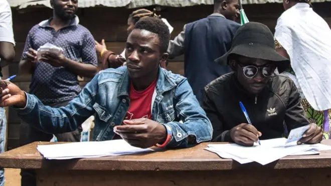 People registering voters in an improvised election in the east of the country