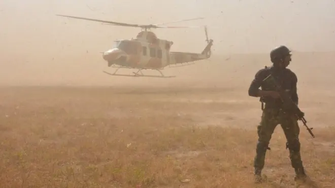 Securtiy officer stand near Nigeria Airforce plane