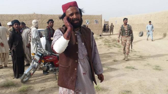 A man who was injured in a suicide bomb attack that targeted an election campaign rally of the Balochistan Awami Party (BAP), talks on a mobile phone, in Mastung, Pakistan, 13 July 2018.