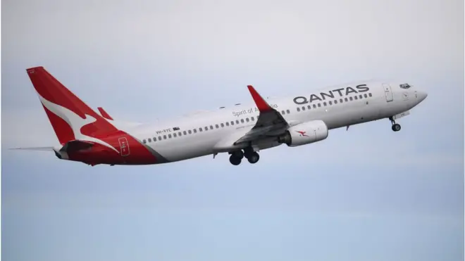 A Qantas 737-800 takes off from Sydney to celebrate the airline's 100th birthday during the pandemic