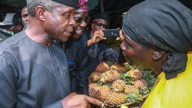 Nigeria Vice President Yemi Osinbajo and one fruit trader