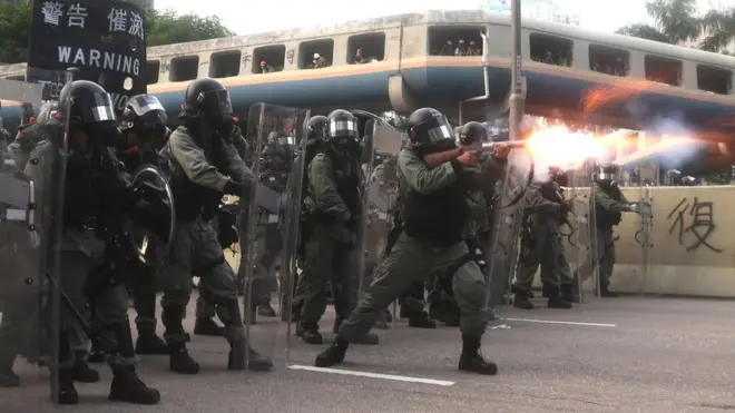 Riot police fire tear gas at protesters in Hong Kong on Saturday