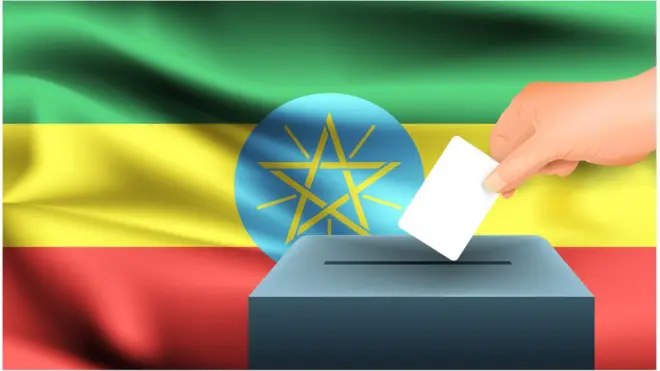 ወደ ድምጽ መስጫ ሳጥን የምርጫ ካርድ የሚከት መራጭ