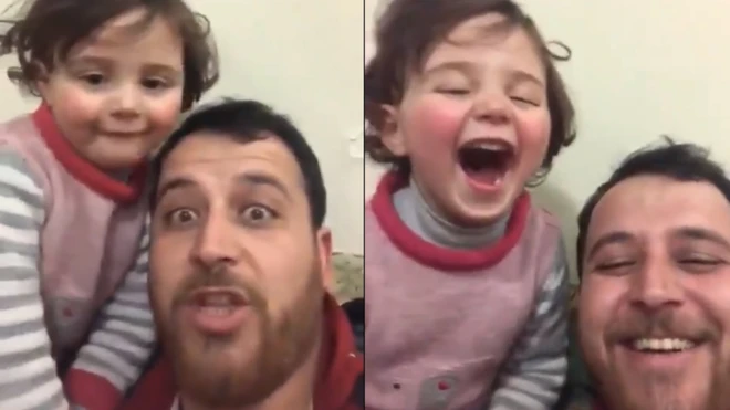 أب سوري وابنته يضحكان على صوت القذائف