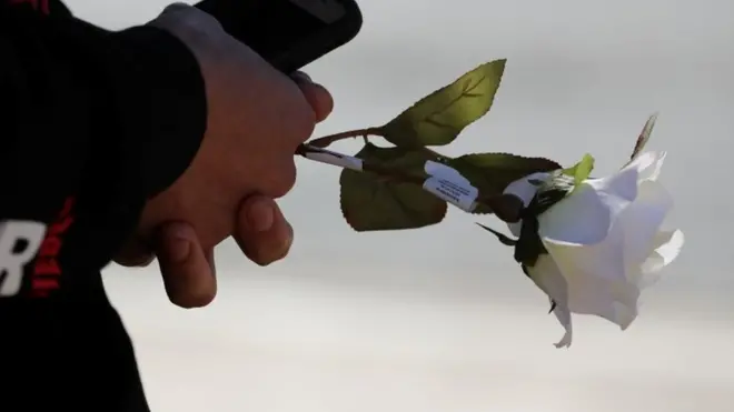 A rose is held in memory of those killed in the Las Vegas mass shooting on 1 October, 2017