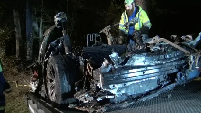 The remains of a Tesla vehicle are seen after it crashed in The Woodlands, Texas