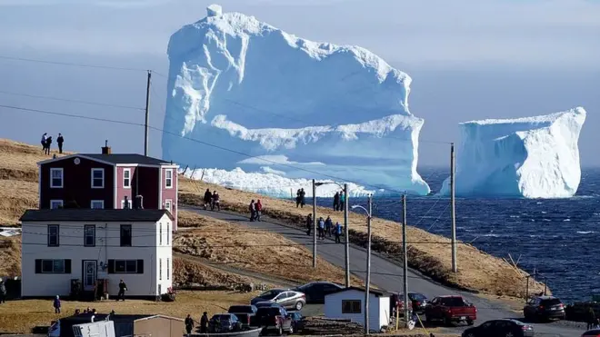 Residents view the first iceberg of the season as it passes the South Shore, also known as "Iceberg Alley", near Ferryland Newfoundland, Canada April 16, 2017.