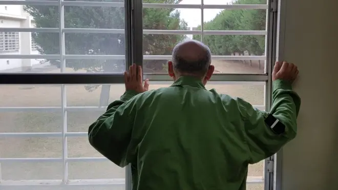 Japanese prisoner looking through bars