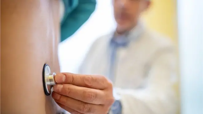 Stock image of a man being examined by a doctor